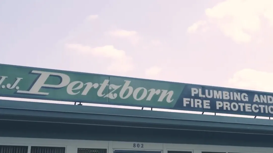 The HJ Pertzborn Plumbing and Fire Protection sign over the company's storefront